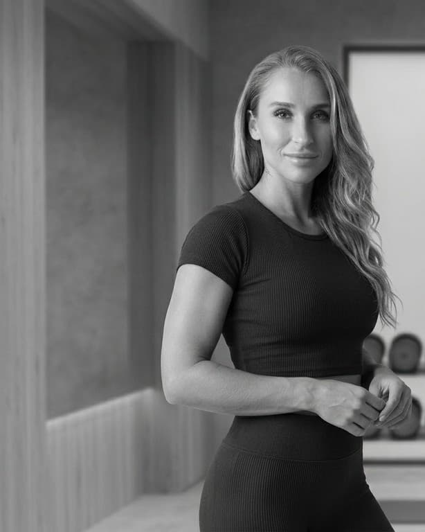 Portrait signature image of Summer standing with calm confidence in a monochrome training space.