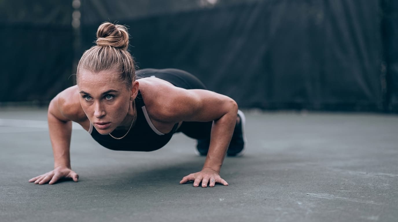 Summer performing a low push-up in a premium sports campaign style.
