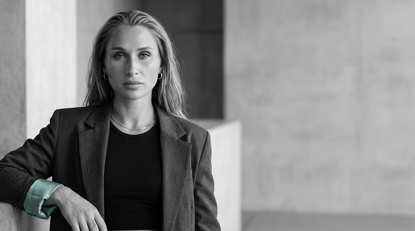 Black and white signature image of Summer in a blazer and black top.