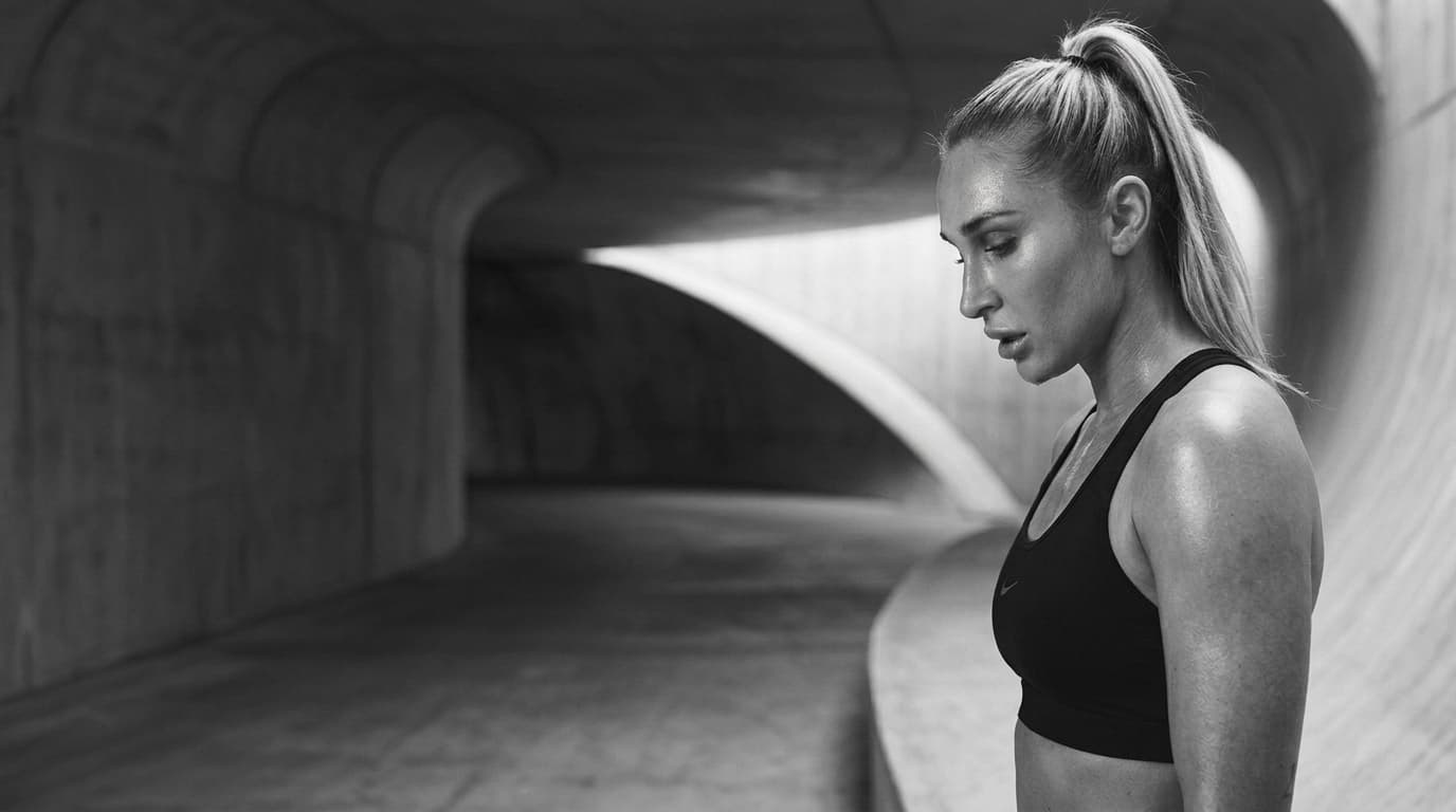 Black and white profile of Summer Loffler in a sculptural training space.